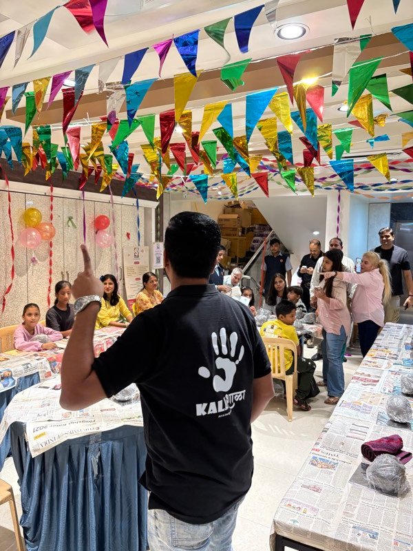 Art workshop participants displaying their finished creations in Pune